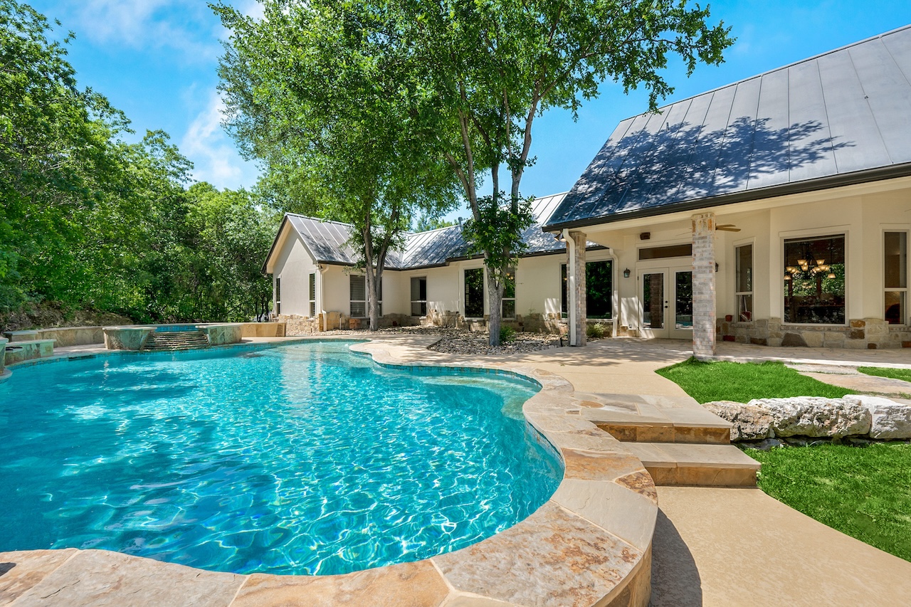 home swimming pool with large shade tree overhead